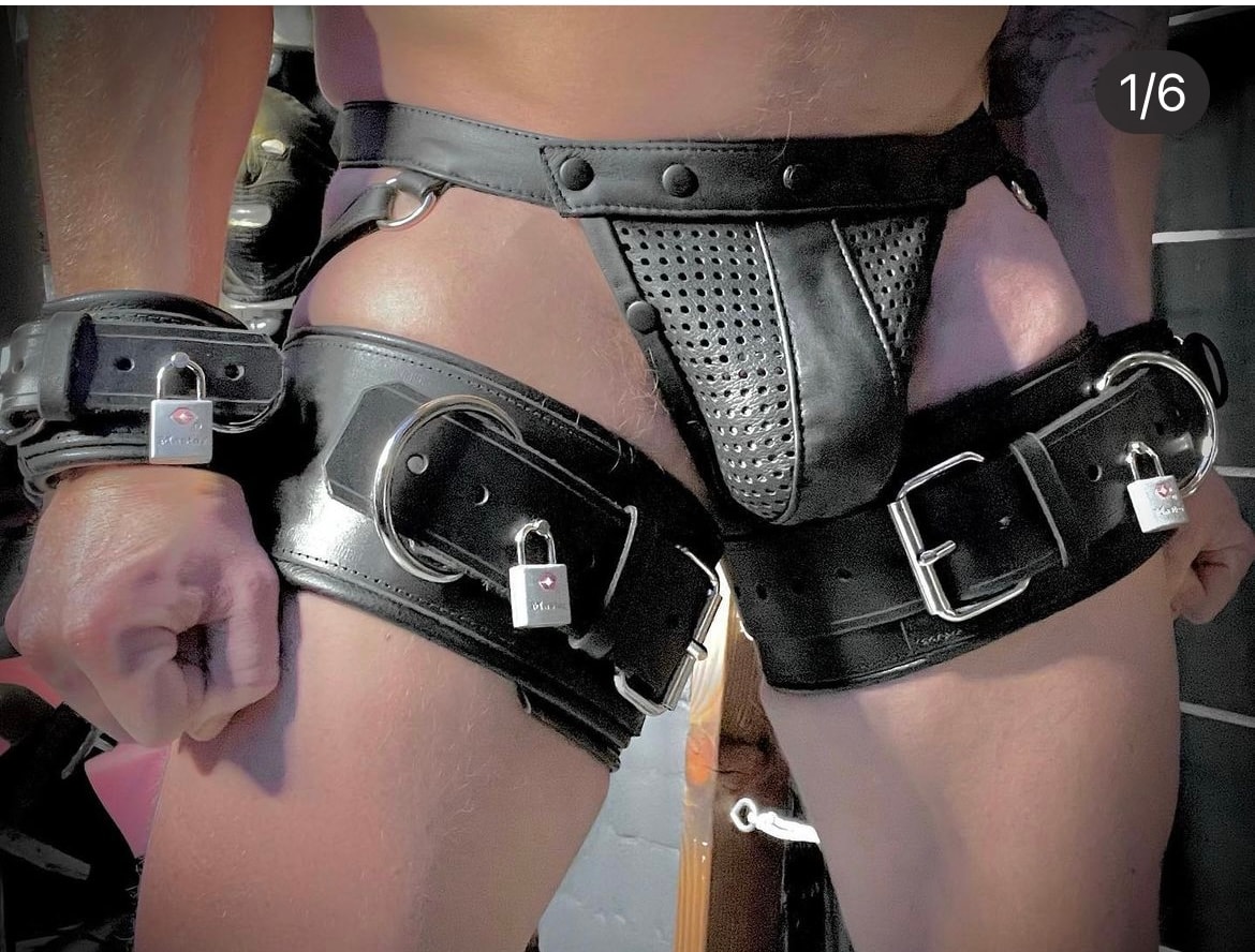 Black leather harness with padlocks worn on body