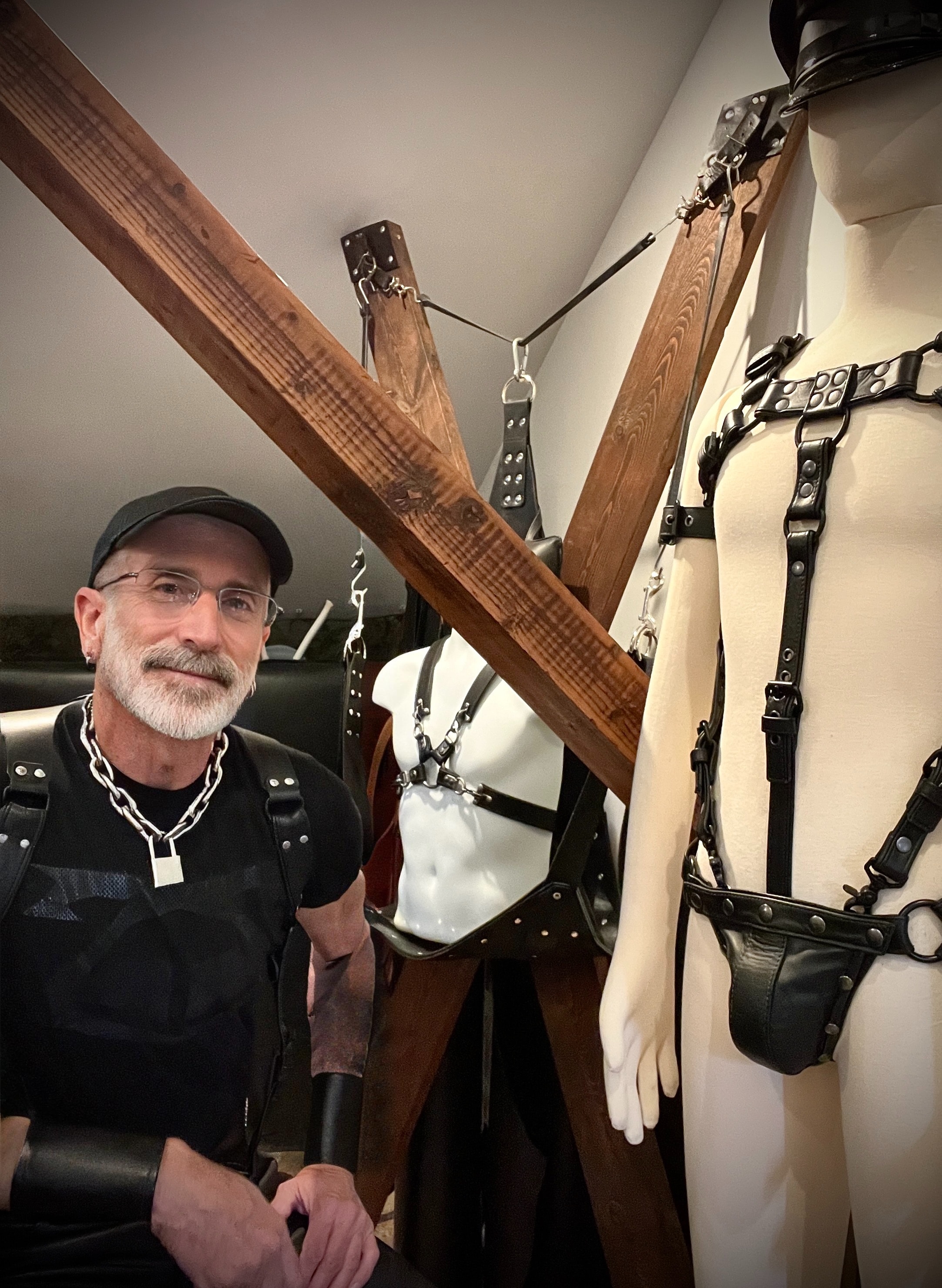 Maker with mannequins and St. Andrew's cross in studio