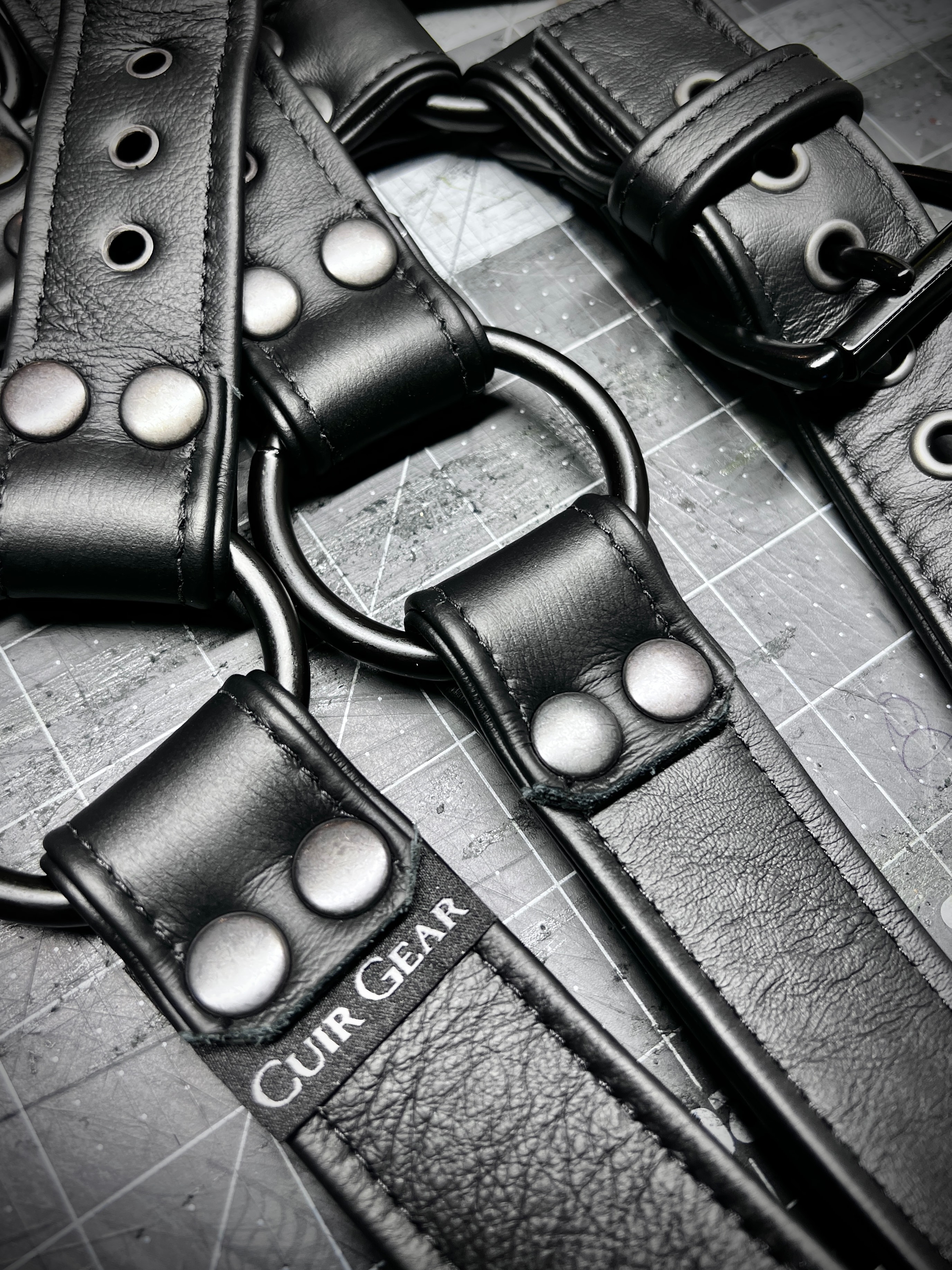 Black studded leather belts flat lay